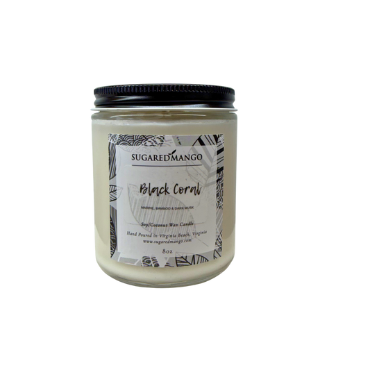 Candle jar labeled 'Black Coral' by Sugared Mango on a white background