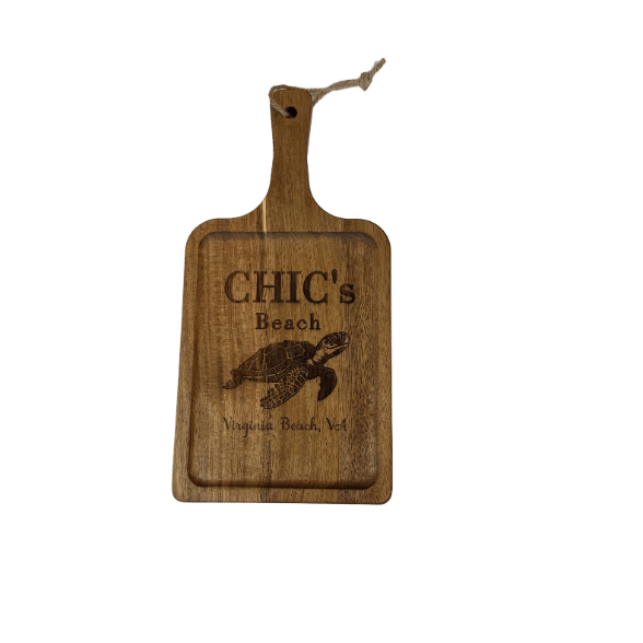 Wooden cutting board with engraved text and turtle design on a white background